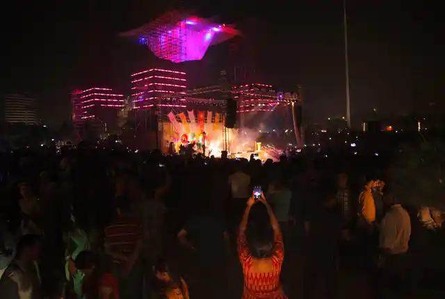 A woman raises her phone as she attends a a four-day laser show organised by the Delhi government to promote a greener Diwali at Connaught Place’s Central Park in New Delhi, India, Saturday, 26 October.