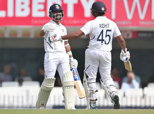 India’s Ajinkya Rahane, left, celebrates with batting partner Rohit Sharma after scoring a century during the second day of third and last cricket test.