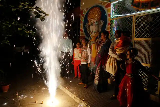 A family bursts firecrackers as part of Diwali celebrations in Uttar Pradesh’s Prayagraj.