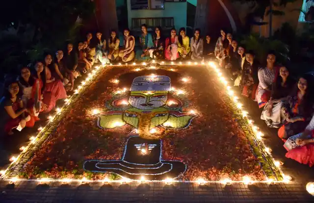 Students of Cotton University decorating Rangoli with Diyas (earthern lamps) on the occasion of Diwali festival in Guwahati.