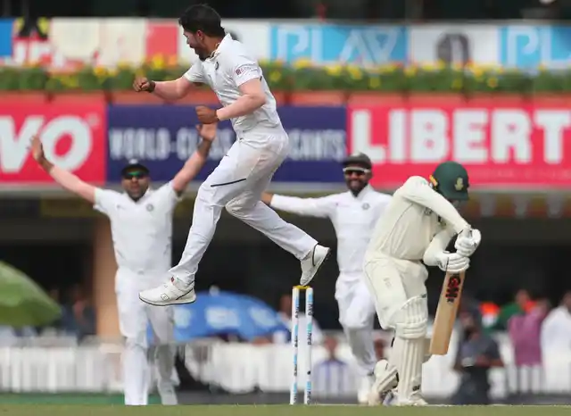 India’s Umesh Yadav leaps in the air to celebrate the dismissal of South Africa’s Quinton de Kock, right, during the third day of third and last cricket test match between India and South Africa in Ranchi, India, Monday, 21 Oct 2019.