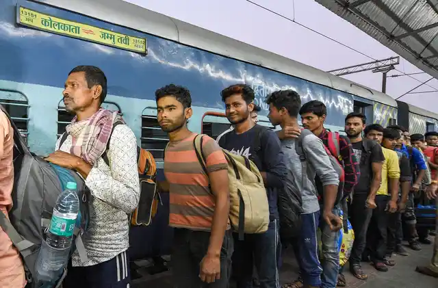 Workers arrive at the station from Jammu and Kashmir, in Kolkata.