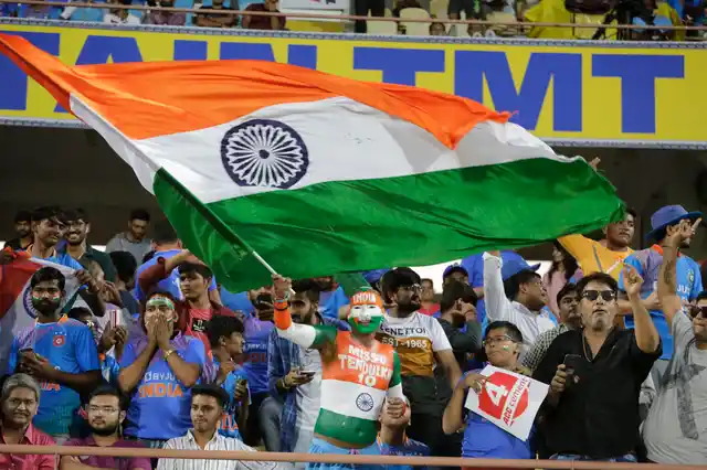 An Indian fan with his body painted cheers and waves Indian flag before the start of second Twenty20 international cricket match between India and Bangladesh at Saurashtra Cricket Association stadium in Rajkot.