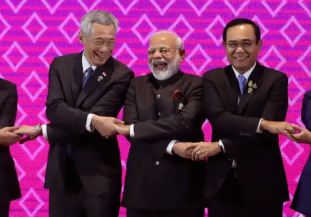 India’s Prime Minister Narendra Modi, center, laughs as he poses for a group photo with Singapore Prime Minister Lee Hsien Loong, left, and Thailand Prime Minister Prayuth Chan-ocha during The Association of Southeast Asian Nations ASEAN-India summit in Nonthaburi, Thailand.