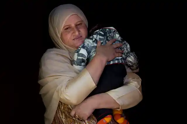 Kashmiri woman Zahida Jahangir is holding her two-month-old son Mohammad Taimor, 17 October 2019. 
