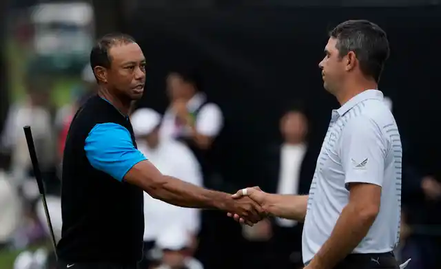 Tiger Woods shakes hands with Gary Woodland on the 18th hole after finishing the third round of the Zozo Championship PGA Tour at the Accordia Golf Narashino country club in Inzai, east of Tokyo, Japan.