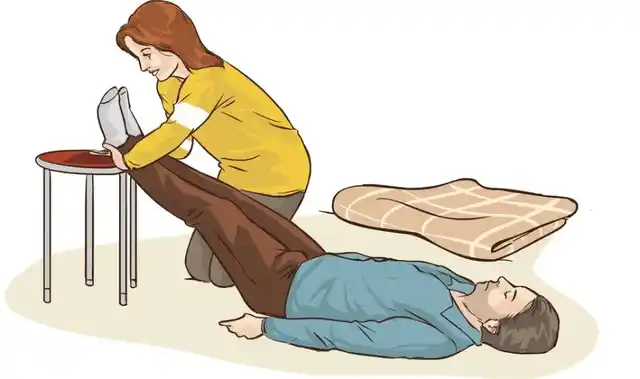 Here’s how to lift the person’s legs above the ground when they’re unconscious.