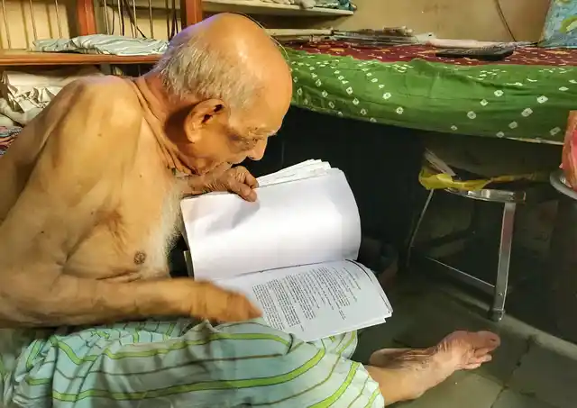 Narayan sifting through his documents.