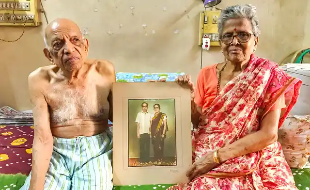 Narayan and Iravati Lavate with an old picture of them from their early days of marriage.