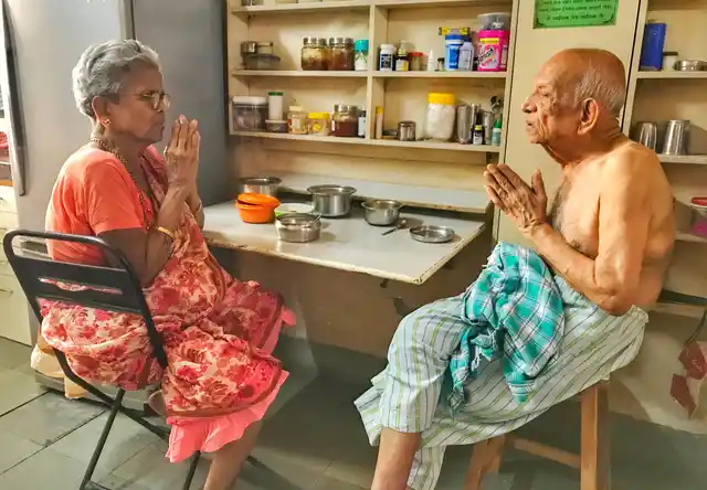 The couple chants a prayer before eating lunch.