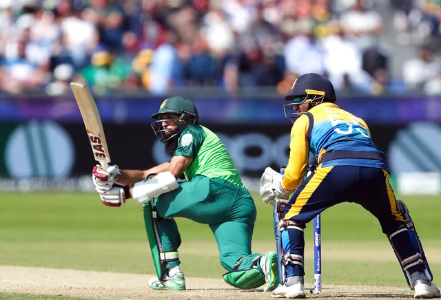 South Africa's batsman Hashim Amla, left, watches his shot.