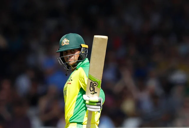 Australia's Usman Khawaja celebrates towards his teams dressing room after getting 50runs.
