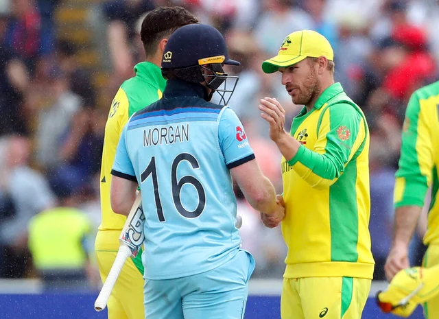 England's captain Eoin Morgan, left, shakes hands with Australia's captain Aaron Finch, right, after winning the Cricket World Cup semi-final.