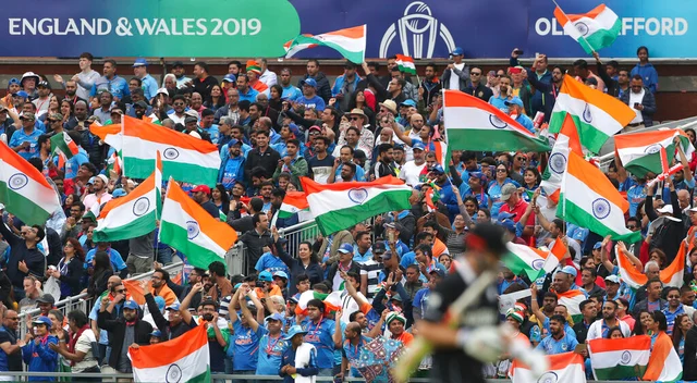 Indian supporters celebrate the dismissal of New Zealand's captain Kane Williamson.