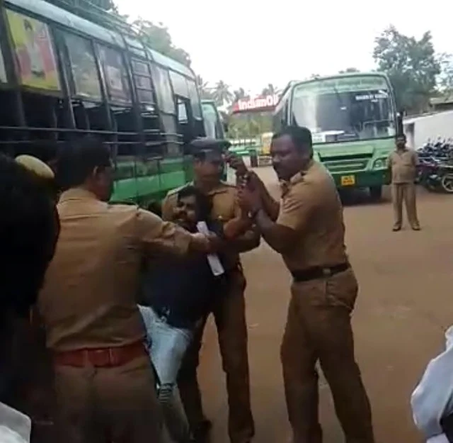 போலீசாரல் தூக்கிவரப்படும் பாலகிருஷ்ணன்