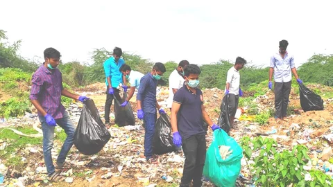 Young people disposing of plastic trash in palaru river