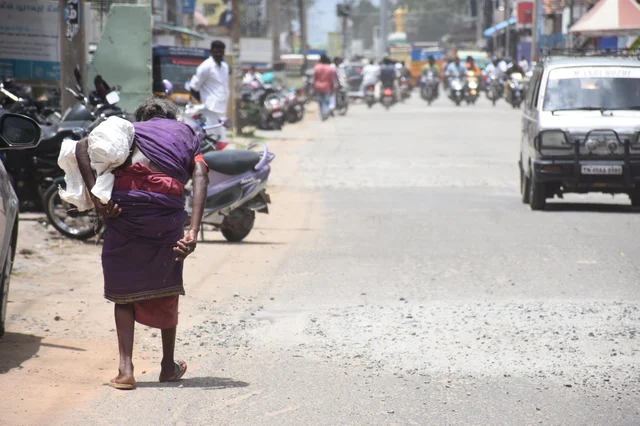 A 75-year elder woman collecting empty boxes for livelihood