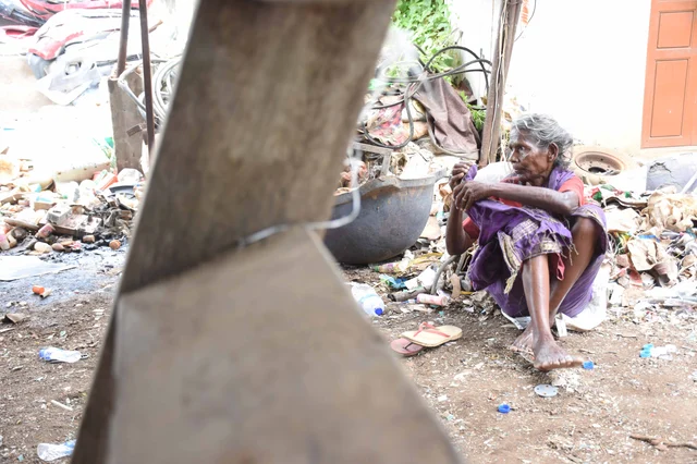 A 75-year elder woman collecting empty boxes