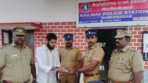 ரயில் பயணியிடம் பணத்தை ஒப்படைக்கும் ரயில்வே போலீஸார்