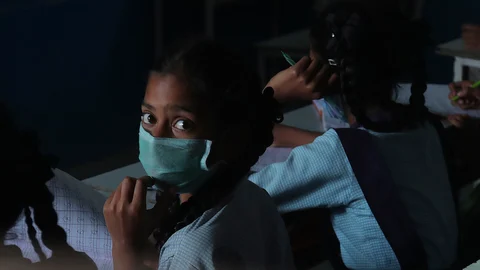 Girl wearing mask to protect from Covid - 19