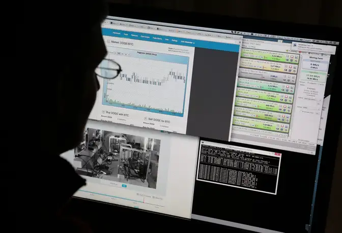 A bitcoin miner is silhouetted as he uses his computer that is set up to mine the crypto-currency at his home in Tokyo, Japan (Photographer: Yuriko Nakao/Bloomberg)