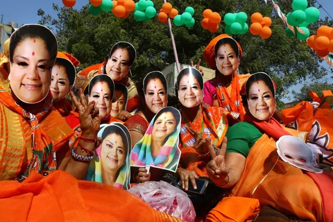 BJP supporters wear masks of Rajasthan Chief Minister Vasundhara Raje in Ajmer, on Dec. 5, 2018. (Photograph: PTI)