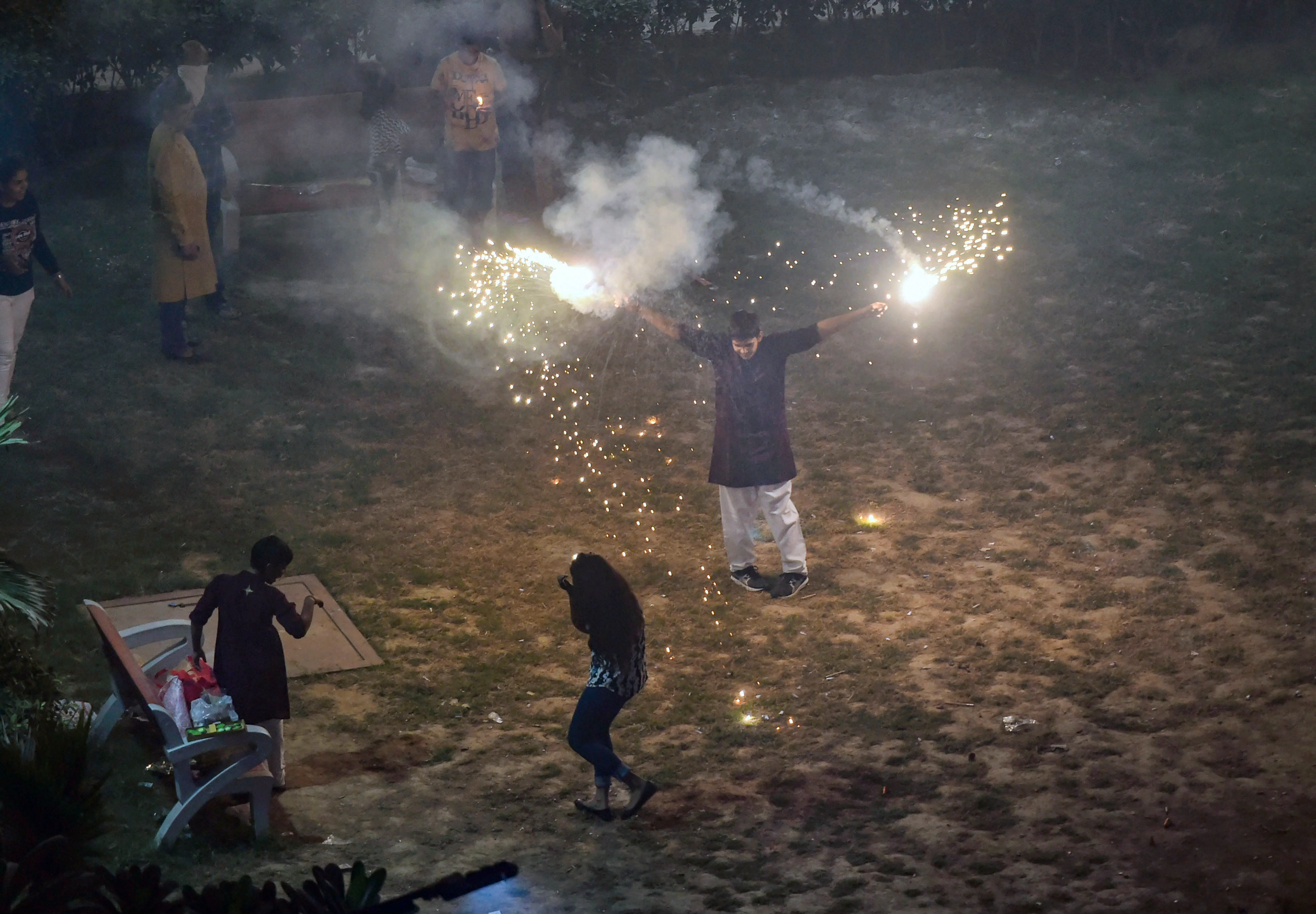 Smoke rises as people burn crackers during Diwali celebrations, in New Delhi on Sunday. (Photo: PTI)