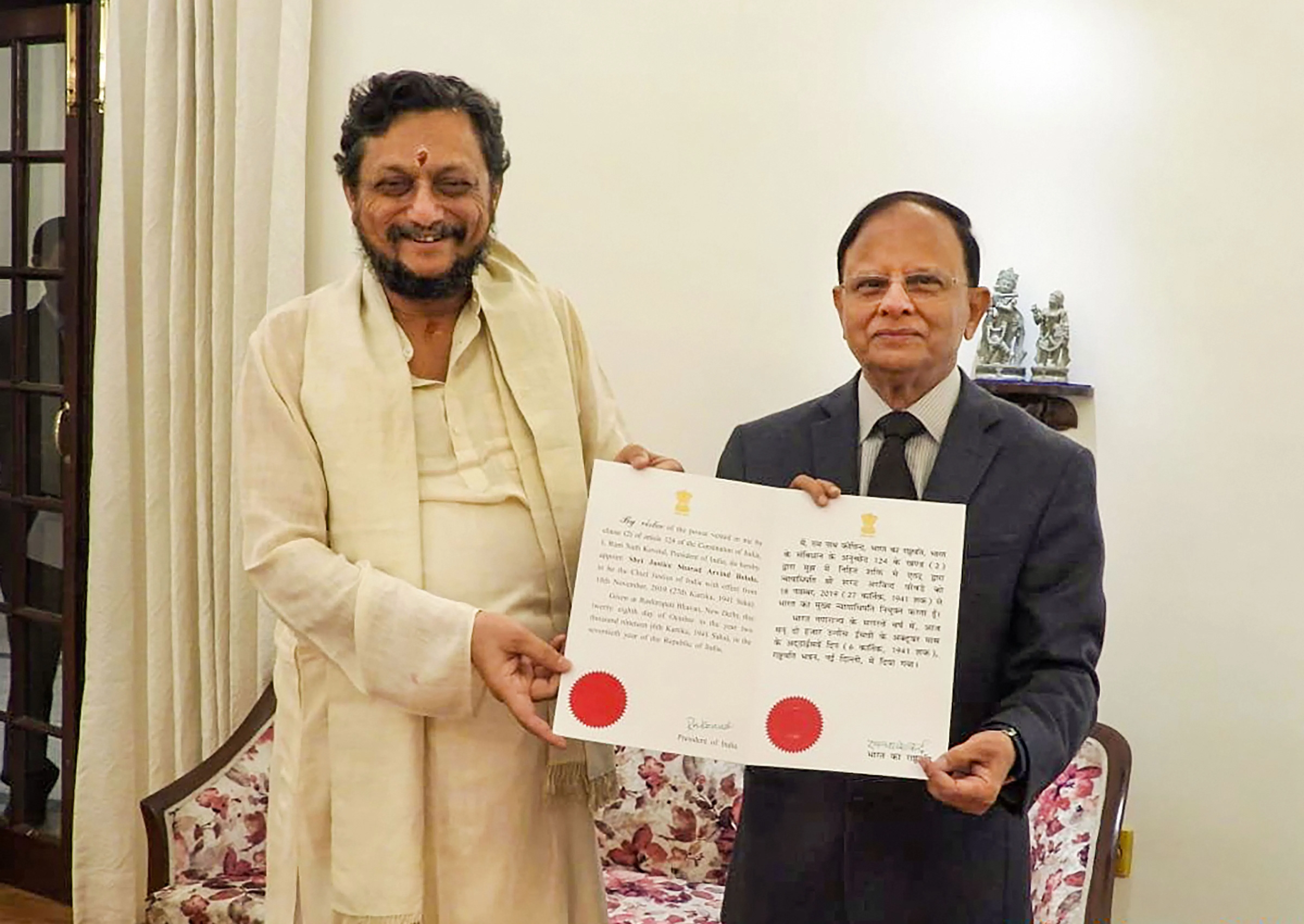 Principal Secretary to Prime Minister PK Mishra presents the warrant of appointment to Chief Justice of India-designate Justice Sharad Arvind Bobde (Source: PTI)