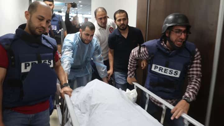 In this file photo, Palestinian cameraman Mujahed al-Saadi (C-L) of Palestine Today TV weeps as he escorts with other journalists the body of veteran Al-Jazeera reporter Shireen Abu Aqleh (Akleh), who was shot dead as she covered a raid on the West Bank's Jenin refugee camp, on May 11, 2022, at the hospital in Jenin. (File photo/AFP)