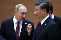Russian President Vladimir Putin speaks to China's President Xi Jinping during the Shanghai Cooperation Organisation (SCO) leaders' summit in Samarkand on September 16, 2022. Photo by Sergei BOBYLYOV / SPUTNIK / AFP