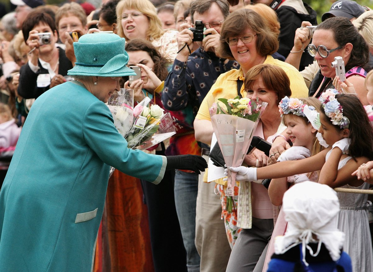 The queen receives flowers during a visit to Williamsburg, Virginia.