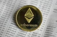 Enthusiasts hope a more energy-efficient Ethereum will spur wider adoption, particularly as a way of enabling banks to automate transactions and other processes. (Photo by ROSLAN RAHMAN / AFP)