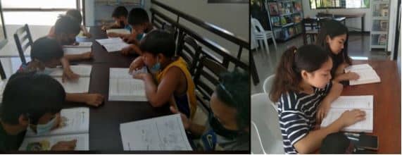 School children from the barangay using the library for study