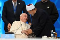 Pope Francis and Egyptian Islamic scholar and the current Grand Imam of al-Azhar mosque, Sheikh Ahmed Al-Tayeb, greet each other during the VII Congress of Leaders of World and Traditional Religions at the Palace of Peace and Reconciliation in Nur-Sultan, Kazakhstan, on 14 September 2022. (Photo by Handout / VATICAN MEDIA / AFP)
