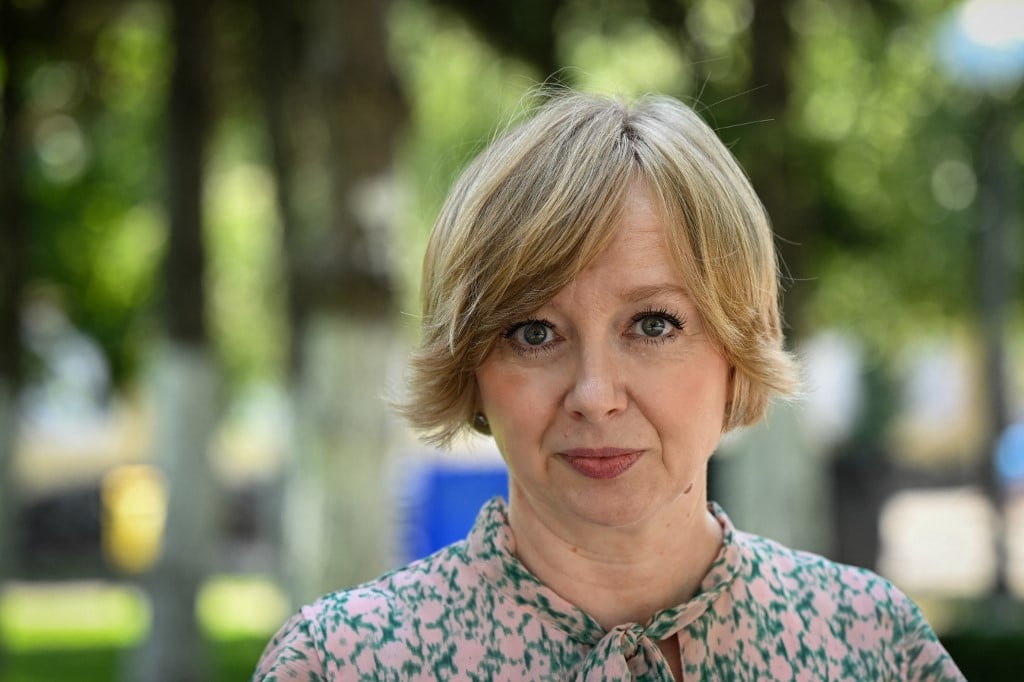 Romanian journalist Emilia Sercan, pictured in Bucharest, Romania, on 26 July 2022, has made it her mission to expose plagiarism at the country's highest levels. But her latest investigation of whether the prime minister, former general Nicolae Ciuca, passed off other people's work as his own in his doctoral thesis has made her the target of a deluge of threats and leaked intimate photos she says are aimed at silencing her. (Photo by DANIEL MIHAILESCU / AFP)
