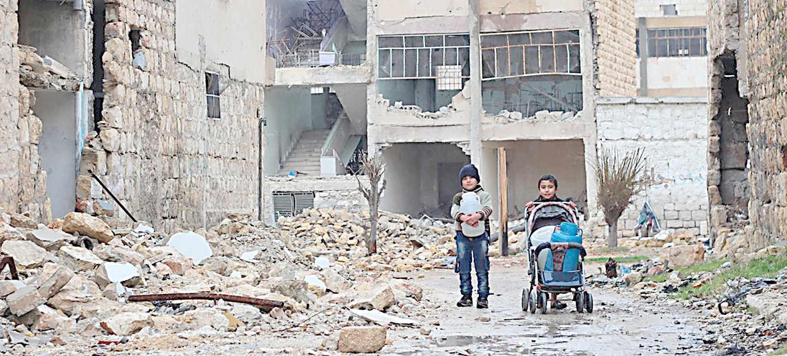 In east Aleppo in Syria, two boys collect water for their family. | Photograph courtesy of UNICEF