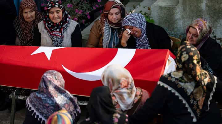 Women react in front of the coffin during a funeral ceremony for Ridvan Acet, one of the miners who died after an explosion in a coal mine in Amasra, in Turkey's Bartin Province, on October 15, 2022. - Rescuers on October 15, 2022 searched for the last miner missing at a coal mine in northern Turkey, where a methane blast the previous day killed at least 40 people in one of the country's worst industrial accidents in years. Photo by Yasin AKGUL / AFP
