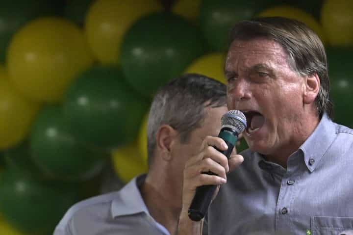 In this file photo taken on 14 October 2022, Brazilian President and reelection candidate Jair Bolsonaro speaks during a meeting with mayors and the governor of the state of Minas Gerais in Belo Horizonte, Brazil. Fighting for reelection in a 30 October runoff against veteran leftist Luiz Inacio Lula da Silva, the far-right president has been swept up in a firestorm over his remarks about the underage Venezuelan girls, whom he called 'very pretty'. (Photo by DOUGLAS MAGNO / AFP)