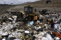 People search through the garbage at the Cerro Patacon municipal dump in Panama City, on 21 September 2022. A new report by the organization Global Alliance for Incinerator Alternatives found that simple tweaks in the waste sector, particularly in urban areas, could slash carbon emissions by the equivalent of the annual emissions of 300 million cars. (Photo by LUIS ACOSTA / AFP)
