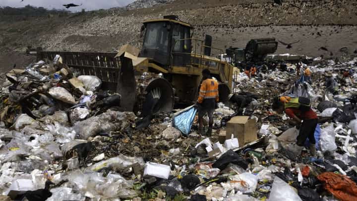 People search through the garbage at the Cerro Patacon municipal dump in Panama City, on 21 September 2022. A new report by the organization Global Alliance for Incinerator Alternatives found that simple tweaks in the waste sector, particularly in urban areas, could slash carbon emissions by the equivalent of the annual emissions of 300 million cars. (Photo by LUIS ACOSTA / AFP)
