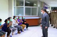 This frame grab from Royal Pool video footage made available via AFPTV on 7 October 2022 shows Thai King Maha Vajiralongkorn (right) meeting with relatives at a hospital in Thailand's Nong Bua Lam Phu, where the monarch met survivors and relatives after a mass shooting by a former police officer at a nursery. (Photo by Royal Pool via AFPTV / AFP)