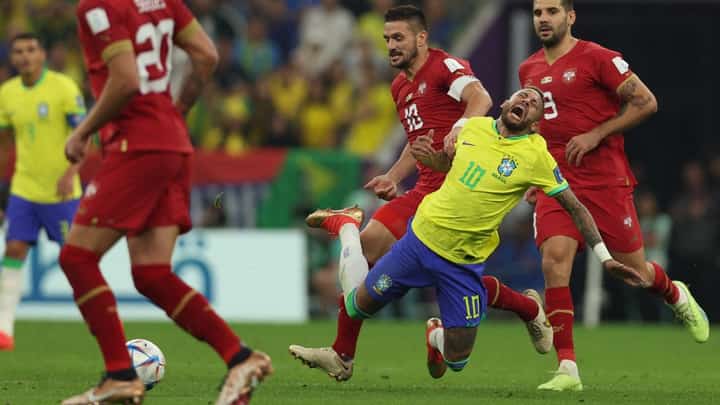 Brazil's forward #10 Neymar (2nd R) is tackled by Serbia's forward #10 Dusan Tadic (3rd R) during the Qatar 2022 World Cup Group G football match between Brazil and Serbia at the Lusail Stadium in Lusail, north of Doha on November 24, 2022. Photo by Adrian DENNIS / AFP