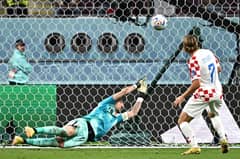 Croatia's midfielder #07 Lovro Majer (R) scores his team's fourth goal past Canada's goalkeeper #18 Milan Borjan (L) during the Qatar 2022 World Cup Group F football match between Croatia and Canada at the Khalifa International Stadium in Doha on November 27, 2022. (Photo by Anne-Christine POUJOULAT / AFP)