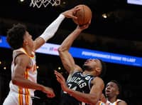 Jalen Johnson of the Atlanta Hawks blocks a shot by Giannis Antetokounmpo of the Milwaukee Bucks during the second half. Photo by Kevin C. Cox / GETTY IMAGES NORTH AMERICA / Getty Images via AFP