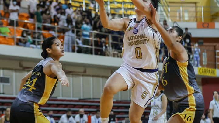 NU's Mikka Cacho scores against UST's Rocel Dionisio (left) and Chille Serrano during the UAAP Seaosn 85 womens basketball round 2 match a the UST Quadricentennial Pavilion, November 19, 2022. Photo by Rio Deluvio