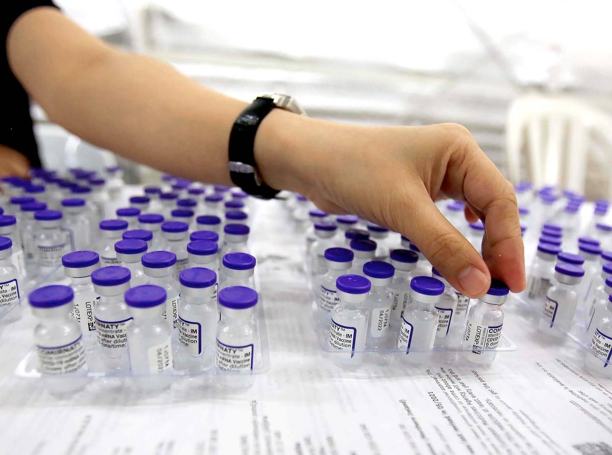 (January 27, 2022)………Health workers prepare Pfizer-BoiNTech covid19 shots for vaccines at a Marikina Mega vaccine center. Vaccine hesitancy among Filipinos had dropped to five percent, a poll released by OCTA research group…….Photo/ Analy Labor