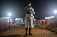 Photo taken on 27 October 2022 shows Jane Apunyo, head nurse of the Mubende referral hospital, maintaining night supervision at the Ebola treatment center in Mubende, Uganda. (Photo by BADRU KATUMBA / AFP)