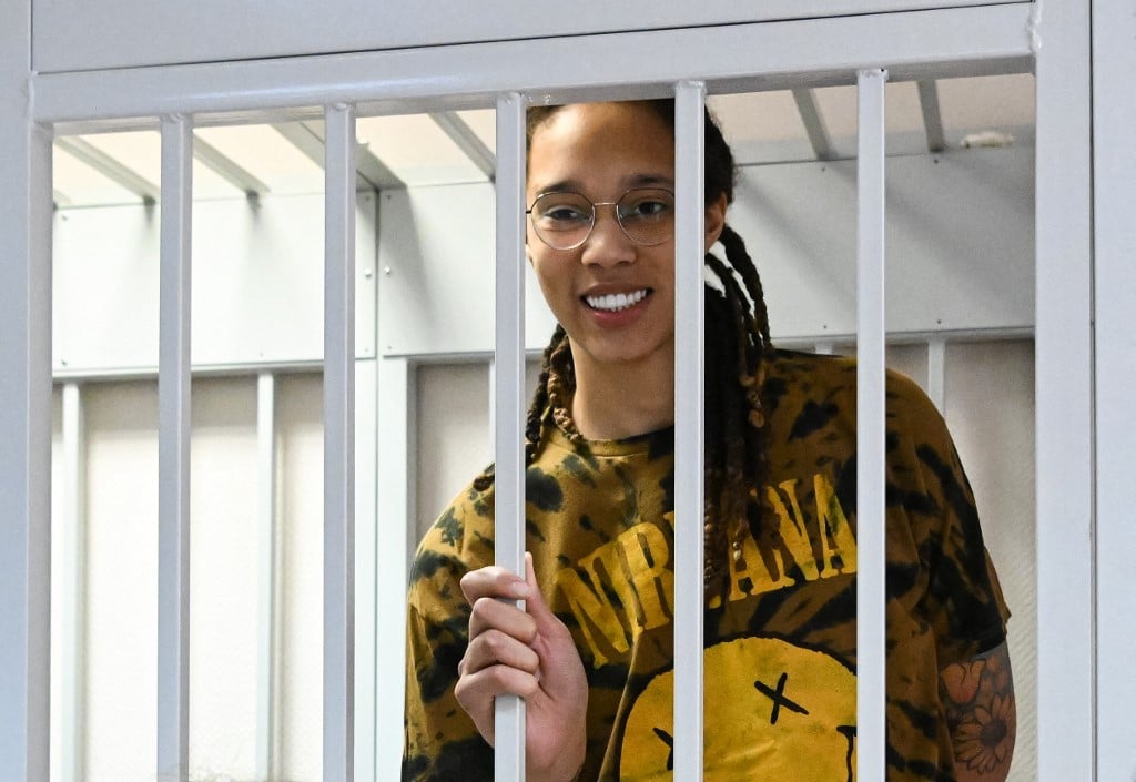 In this file photo taken on 15 July, US WNBA basketball superstar Brittney Griner smiles inside a defendants' cage during a hearing at the Khimki Court in the town of Khimki outside Moscow. Moscow confirmed on December 8, 2022 it had exchanged US basketball star Brittney Griner, who had been jailed in Russia, for notorious arms trafficker Victor Bout who was serving a 25-year sentence in the United States. Photo by NATALIA KOLESNIKOVA / AFP