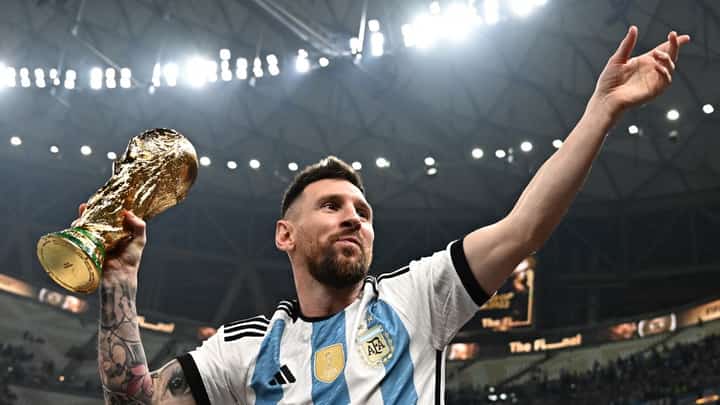 LIONEL Messi displays the trophy after leading Argentina to a dramatic penalty shootout victory over France in the final of the World Cup. Photo by Anne-Christine POUJOULAT / AFP