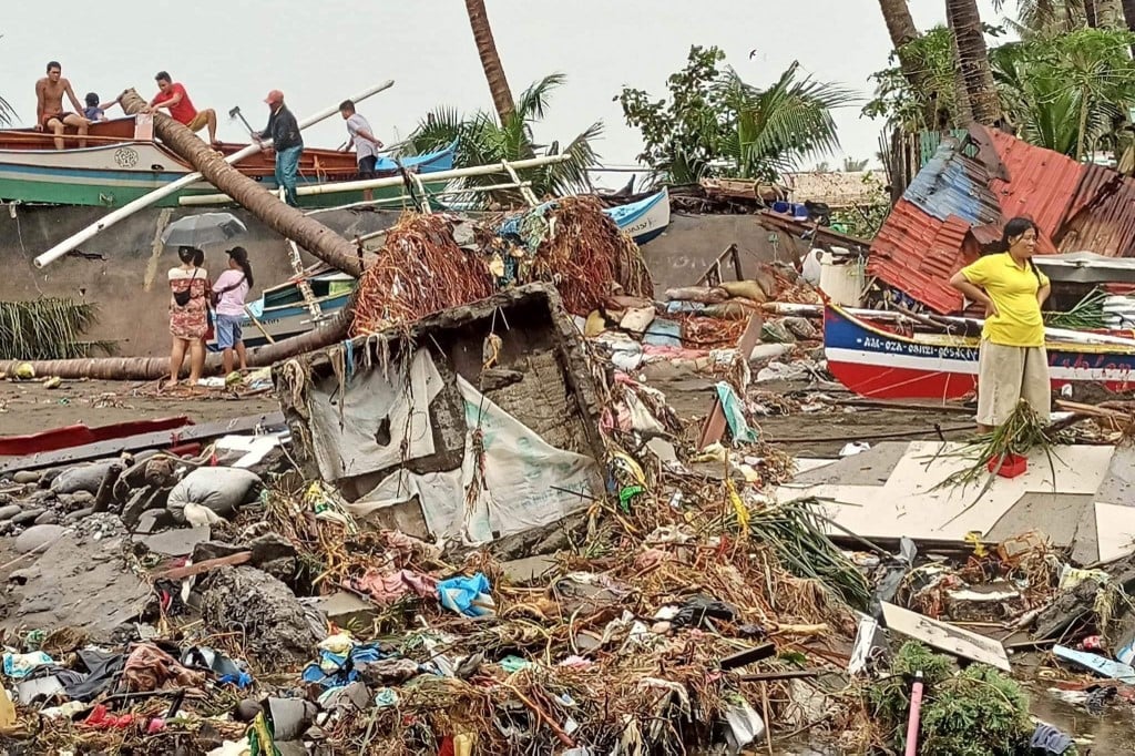 This handout photo courtesy of Angelica Villarta taken on 27 December and received on 28 December shows residents surveying damage caused by heavy rain and floods in Oroquieta City, Misamis Occidental. Photo by Handout / Angelica Villarta / AFP